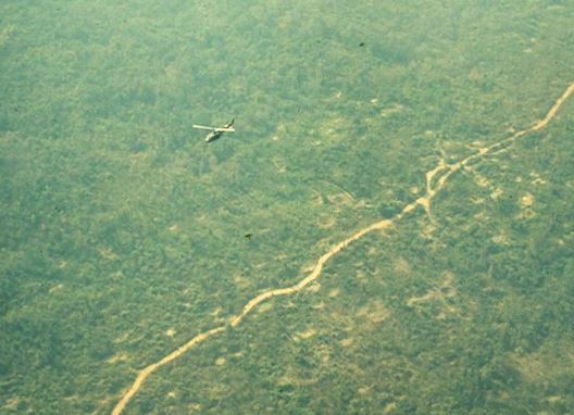 Helicopter over the Ho Chi Minh Trail in Laos (Fred Thompson 174ahc.org).