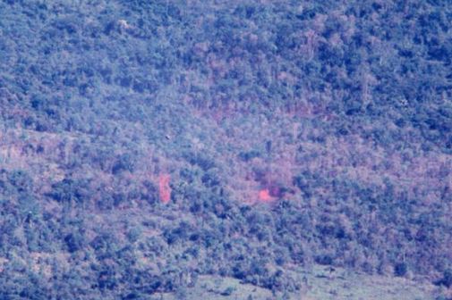 A 20th Helicopter jungle extraction – a chopper hovers over the popped red smoke on the left hand side of the photo. (© Jim Green 20th SOS)