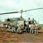 A 20th SOS Huey gunship team waiting near the Vietnamese border for a pickup call from a SOG team in Laos or Cambodia. Note the rocket pods (Jim Green).
