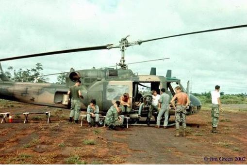 A 20th SOS Huey gunship team waiting near the Vietnamese border for a pickup call from a SOG team in Laos or Cambodia. Note the rocket pods (Jim Green).